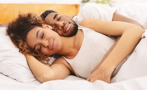 Preview: Loving couple sleeping in bed and hugging