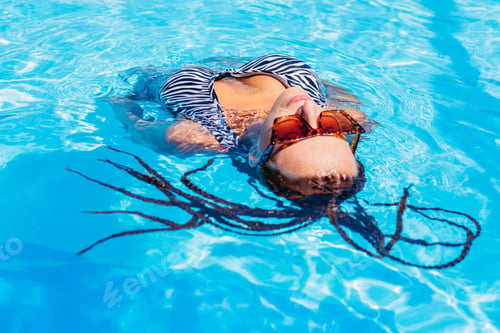 Preview: Swimming Pool. Sportive Woman In A Swimsuit Swims In The Pool. Portrait.