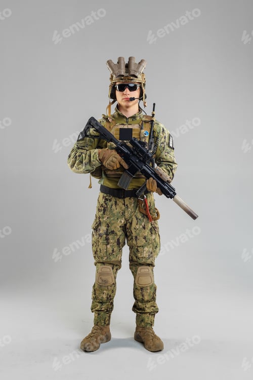 Preview: Soldier stands ready with weapon in tactical uniform during training session indoors