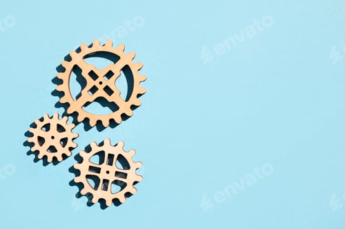 Preview: Wooden gears on a blue background. Flat lay, place for text.