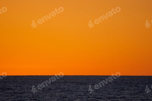 Preview: Wow! Amazing awesome orange sunset turned the whole sky smooth and peaceful over the ocean.