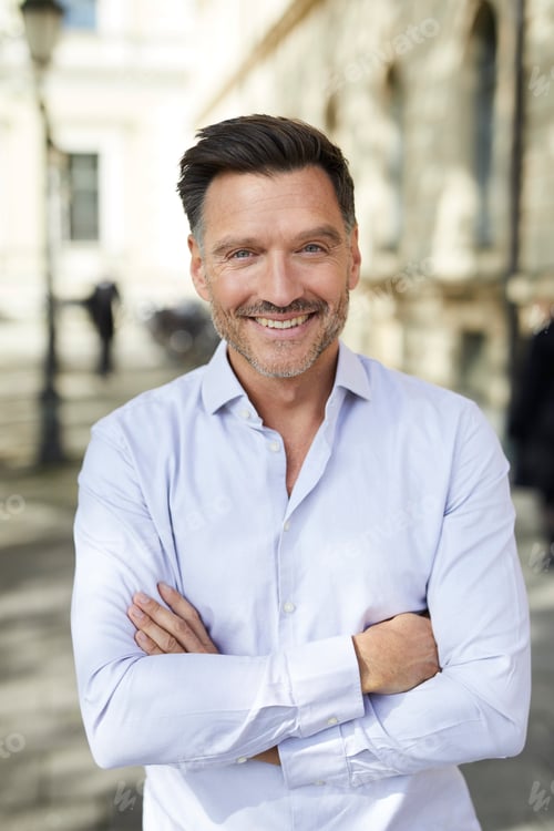 Preview: Portrait of smiling businessman in the city