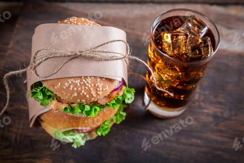 Preview: Takeaway homemade hamburger with cold drink on old wooden table