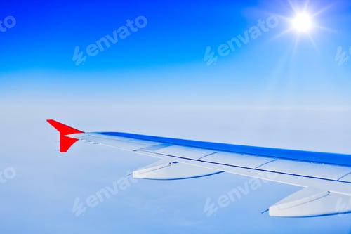 Preview: Wing aircraft in altitude during flight with sunlight, copy space. Aviation, travel