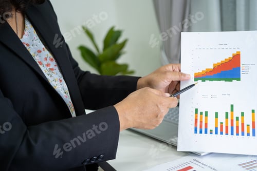 Preview: Asian accountant working and analyzing financial reports project accounting with chart graph