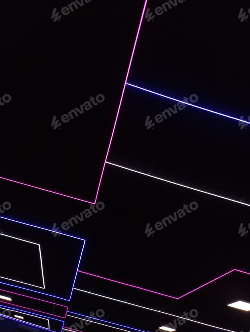 Preview: Vertical shot of a dark black room with colorful neon lights on the ceiling
