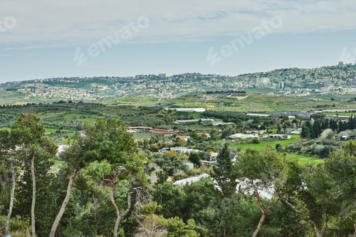 Preview: A breathtaking natural landscape with rolling green hills, olive trees, and distant farmlands