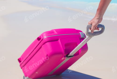 Preview: Young traveler with his luggage on a tropical beach