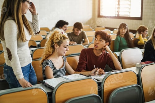 Preview: Mature teacher working with students inside classroom at school university - Focus on asian guy face