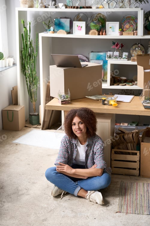 Preview: Happy woman enjoying work in own gift store