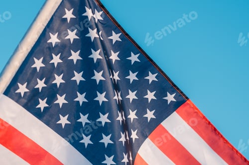 Preview: American flag in a blue sky, close up