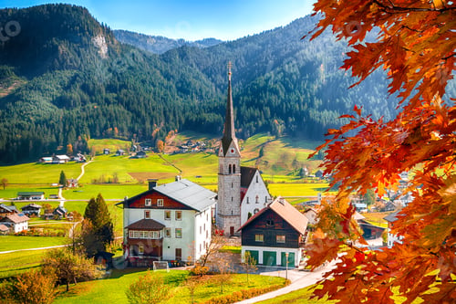Preview: Alpine green fields and traditional wooden houses view of the Gosau village at autumn sunny day.