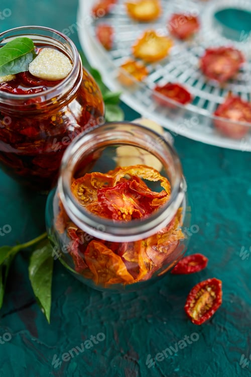 Preview: Homemade sun dried tomatoes with herbs, garlic in olive oil in a glass jar