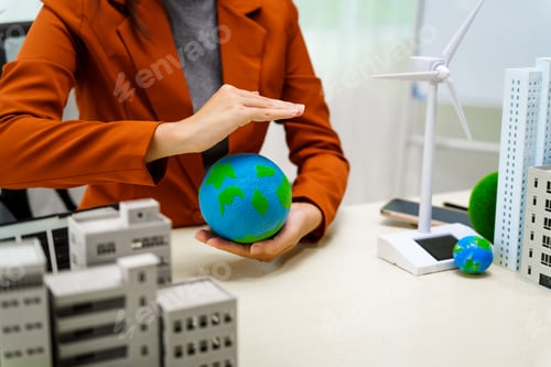 Preview: A businesswoman in a brown suit stands at white desk with world model, electric car model net zero