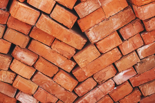 Preview: Stack of bricks close up. Process of house building and building materials concept. Brick wallpaper