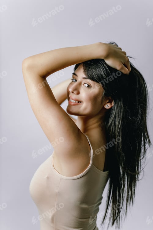 Preview: Smiling Woman Poses in Tank Top Indoors