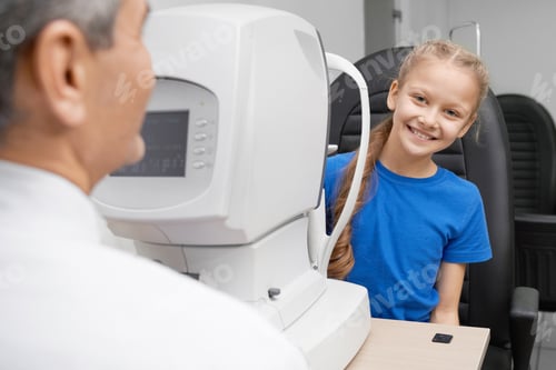 Preview: Girl looking at camera and laughing while checking vision