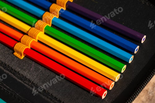 Preview: multi-colored pencils in a schoolboy's pencil case