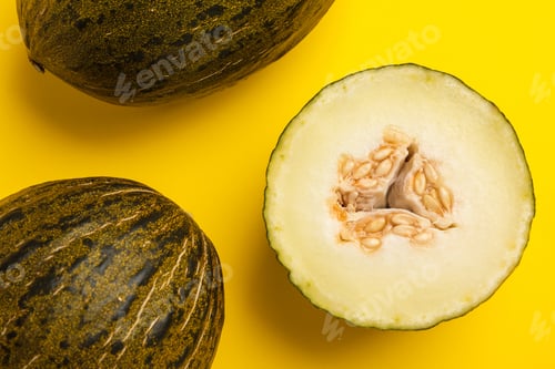 Preview: Ripe tasty melons on yellow background, flat lay