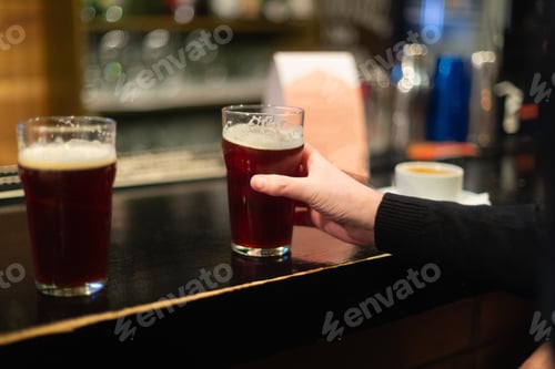 Preview: Beer glasses with dark beer are on the bar counter