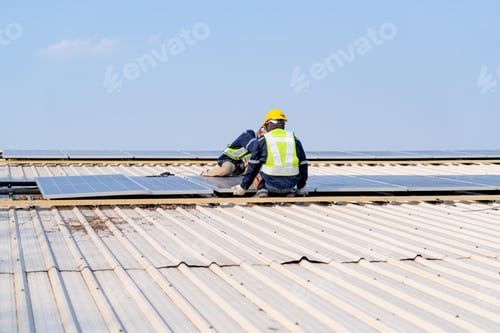 Preview: workers installing solar panels, for efficient energy on rooftop