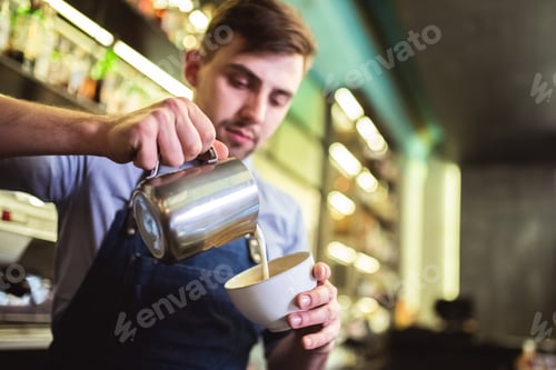 Preview: The happy man making a coffee on the bar
