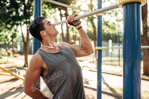 Preview: Athletic man pulled up on one hand outdoor
