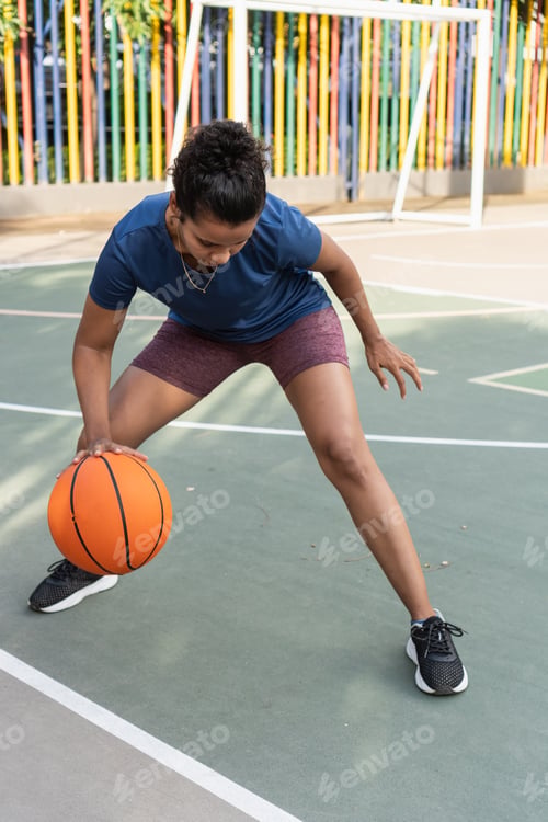 Preview: Woman dribbling basketball on court for exercise