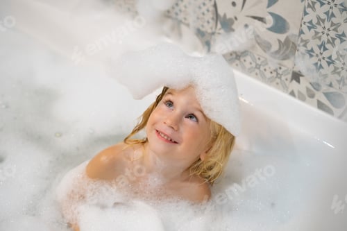 Preview: Cute funny caucasian blonde three years old baby girl taking bath