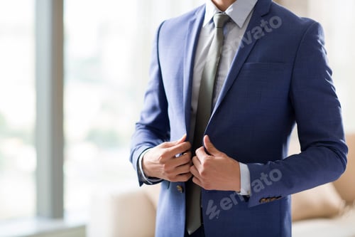 Preview: Young businessman getting dressed in the morning