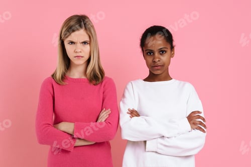 Preview: Multiracial girls frowning while posing with arms crossed