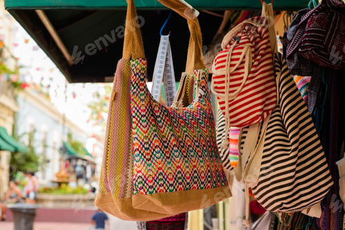 Preview: Backpacks, purses and handbags made with typical Mexican fabrics hanging outside souvenir stores.