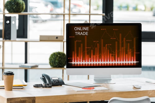 Preview: close up view of workplace with computer screen with online trade lettering in office