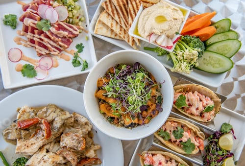 Preview: A variety of freshly made apps and entrees shot from overhead.