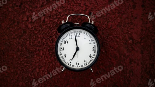 Preview: Retro black alarm clock on red background with copy space.