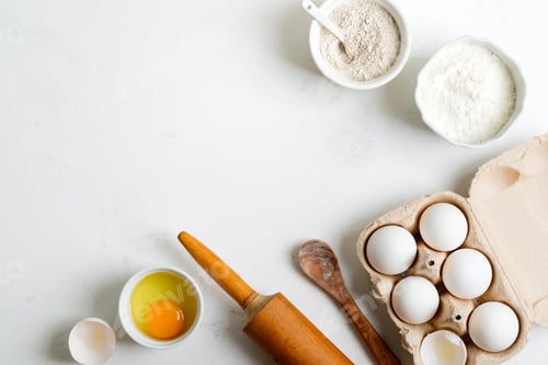 Preview: Baking ingredients for making homemade traditional bread or cakes on a light grey marble background