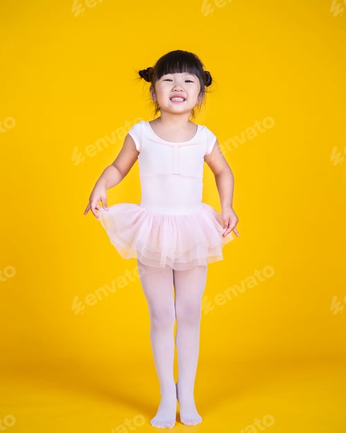 Preview: Smiling Girl in Ballet Tutu on Yellow Background