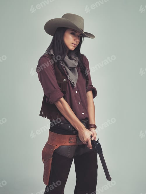 Preview: I got my eye on you...Cropped shot of an attractive young woman in cowboy attire.