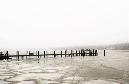 Preview: Cold gray foggy morning at the cold frozen lake and dock
