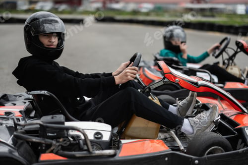 Preview: Children Enjoying Go-Kart Racing Outdoors for a Fun and Exciting Adventure
