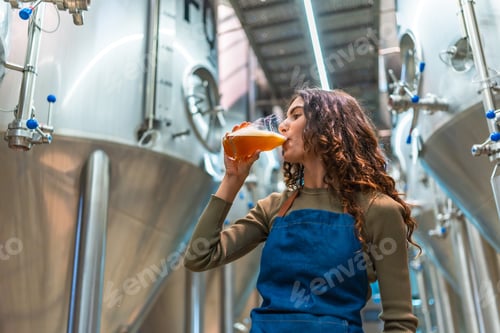 Preview: Woman tasting craft beer for quality control in brewery
