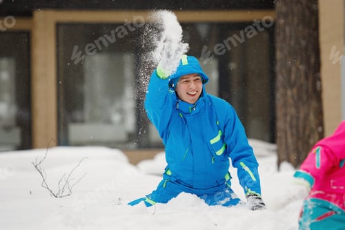 Preview: Family wallowing and having fun on white snow in the winter park.