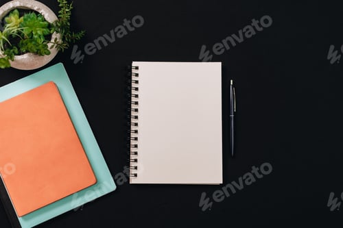 Preview: blank open notebook on black work desk with room for copy or print mock up element