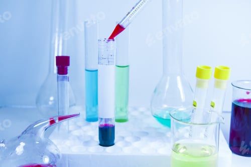 Preview: Closeup of different beakers and tubes with chemicals on the table in a laboratory