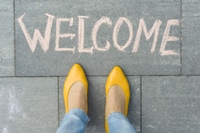 Preview: Bright Shoes Stand on Welcome Message