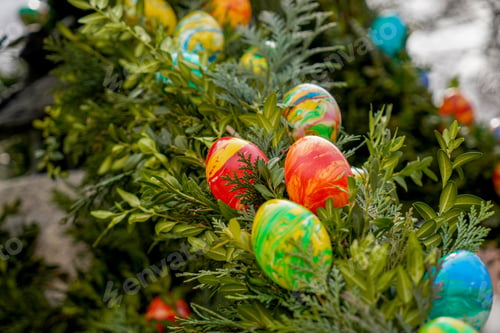 Preview: Selective focus of colorful Easter eggs on a tree in a park