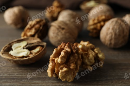 Preview: Walnuts with kitchen towel on wooden background