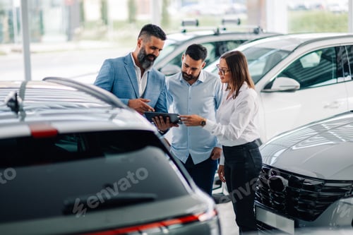 Preview: Modern car sales discussions with a tablet in dealership floor.
