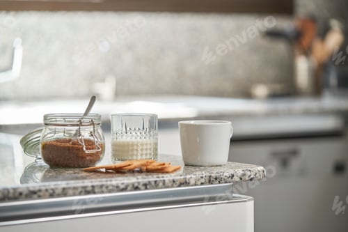 Preview: Cup of fresh coffee with glass of milk and cookies near sugar bo