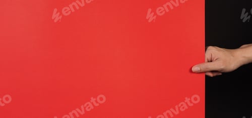 Preview: Hand is holding the red board on black background.